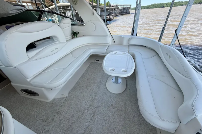 Slide: The Image of 2001 Sea Ray 410 Sundancer boat interior with white seating and small table. - 5