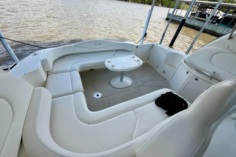 Slide: The Image of 2001 Sea Ray 410 Sundancer boat interior with white seating and small table. - 6