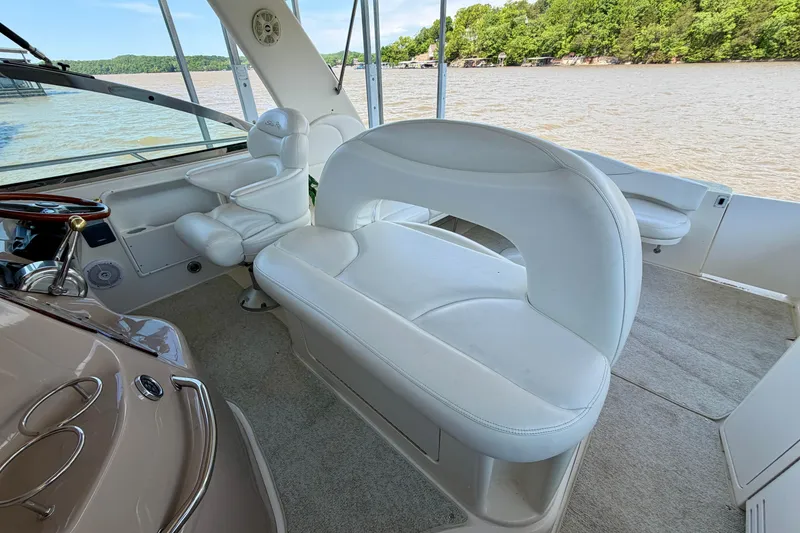 Slide: The Image of Interior of 2001 Sea Ray 410 Sundancer boat with white seating and helm. - 7