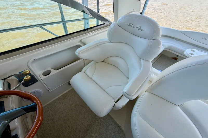 Slide: The Image of Luxurious white seating on 2001 Sea Ray 410 Sundancer yacht, overlooking water. - 8