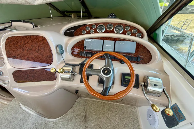 Slide: The Image of Helm of 2001 Sea Ray 410 Sundancer with wood accents and modern controls. - 9