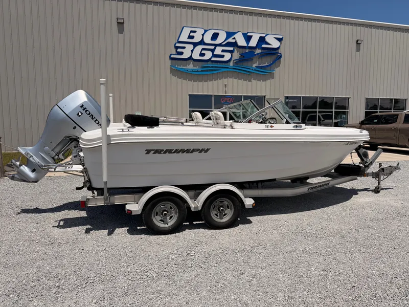 The Image of 2011 Triumph 191 FS boat in front of a boat dealership. - 0