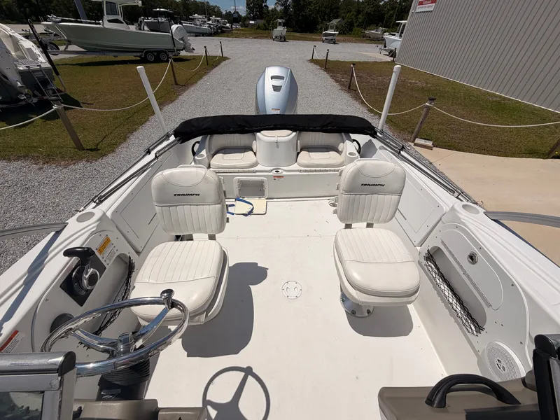Slide: The Image of Interior view of a 2011 Triumph 191 FS boat with white seating. - 11