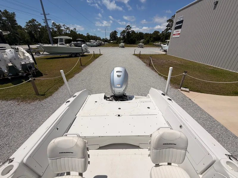 Slide: The Image of 2011 Triumph 191 FS boat parked outdoors on a sunny day. - 12