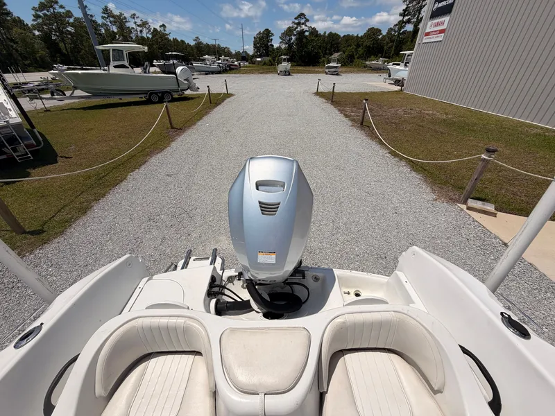 Slide: The Image of 2011 Triumph 191 FS boat with outboard motor on gravel path. - 14