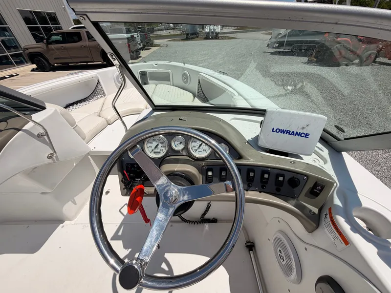 Slide: The Image of Interior view of a 2011 Triumph 191 FS boat with steering wheel and Lowrance device. - 9