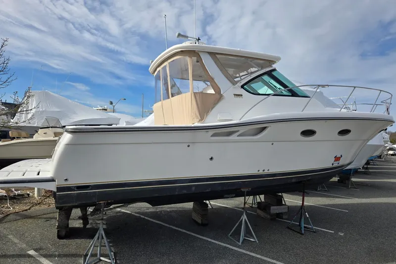 Slide: The Image of 2006 Tiara Yachts 3200 Open boat on stands, side view under a cloudy sky. - 10