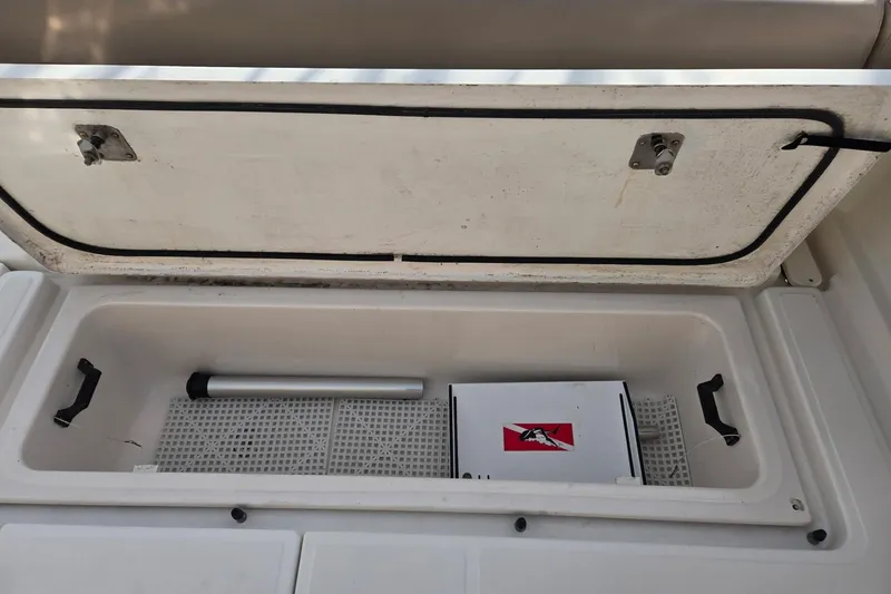 Slide: The Image of Storage compartment of a 2006 Tiara Yachts 3200 Open, featuring a hatch and interior items. - 16