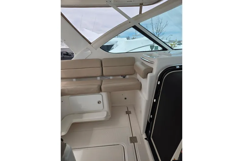 Slide: The Image of Interior of 2006 Tiara Yachts 3200 Open with beige seating and sleek design. - 18