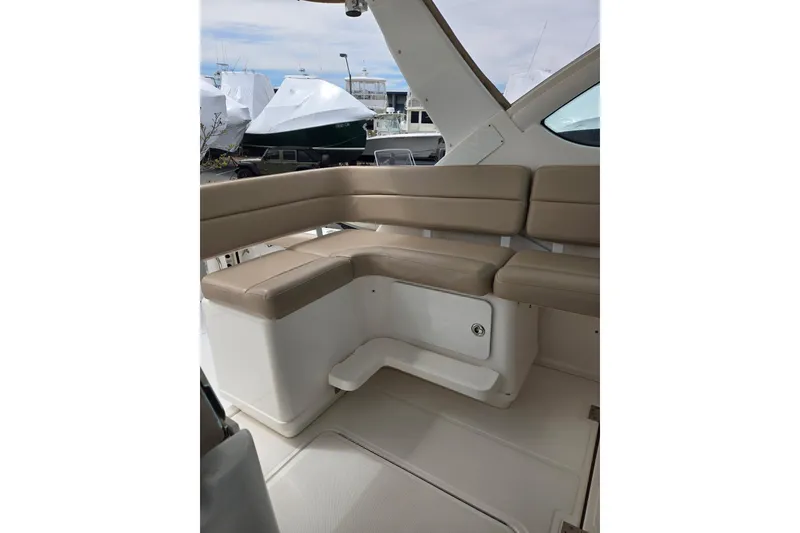 Slide: The Image of 2006 Tiara Yachts 3200 Open interior with beige seating and storage compartment. - 19