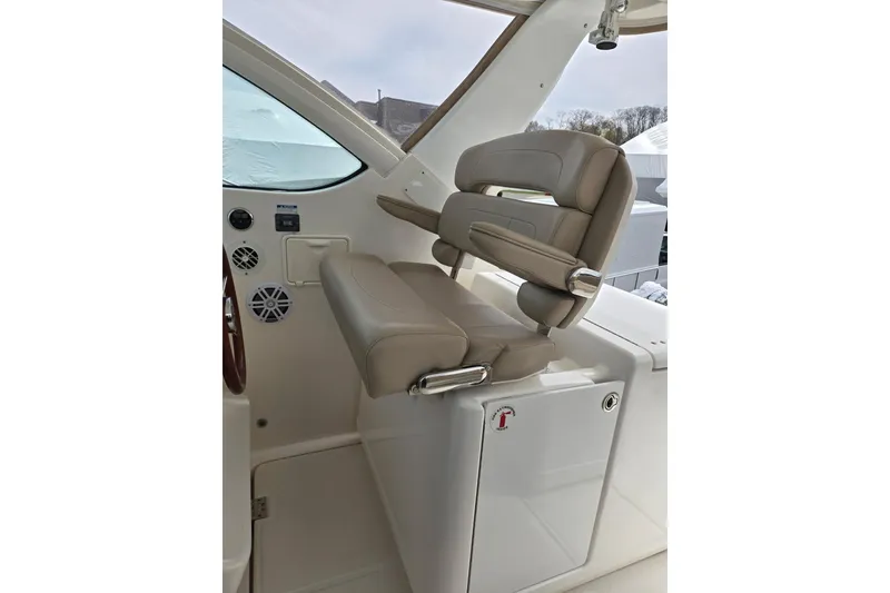 Slide: The Image of 2006 Tiara Yachts 3200 Open helm seat with beige upholstery and control panel. - 20