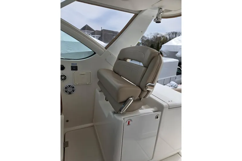 Slide: The Image of Captain's seat on 2006 Tiara Yachts 3200 Open, featuring beige upholstery and sleek design. - 22