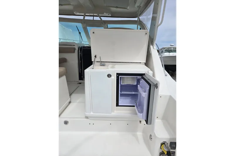 Slide: The Image of 2006 Tiara Yachts 3200 Open with open mini fridge in cockpit area. - 26