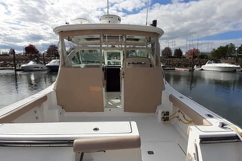 Slide: The Image of 2006 Tiara Yachts 3200 Open docked at marina under cloudy sky. - 3