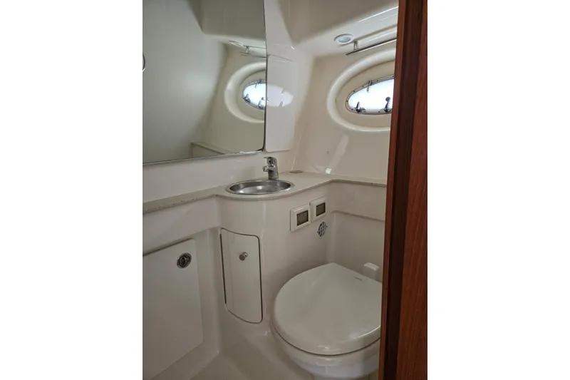 Slide: The Image of 2006 Tiara Yachts 3200 Open bathroom with sink, toilet, and porthole window. - 30
