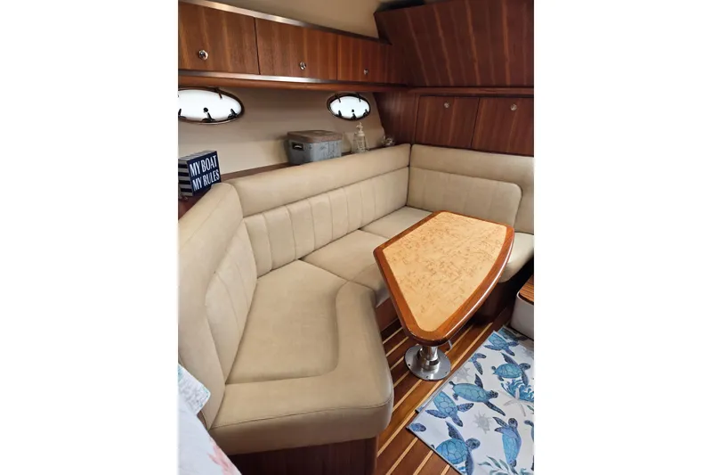 Slide: The Image of Luxurious interior of 2006 Tiara Yachts 3200 Open with plush seating and wooden table. - 31