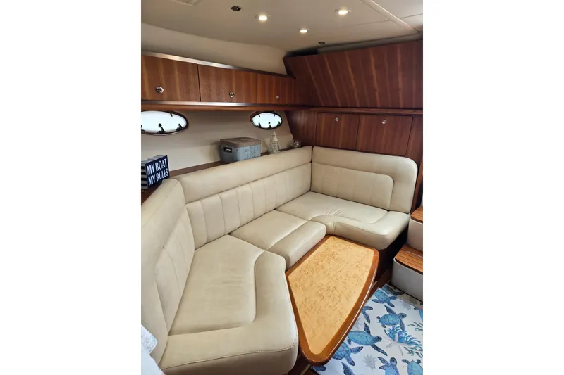 Slide: The Image of Luxurious interior of 2006 Tiara Yachts 3200 Open with plush seating and wooden accents. - 33
