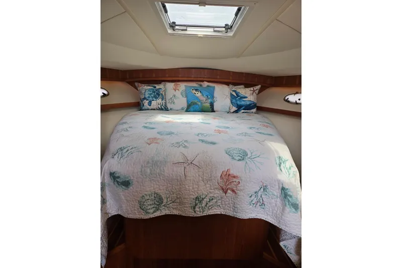 Slide: The Image of Cozy cabin interior of 2006 Tiara Yachts 3200 Open with nautical-themed bedding. - 35