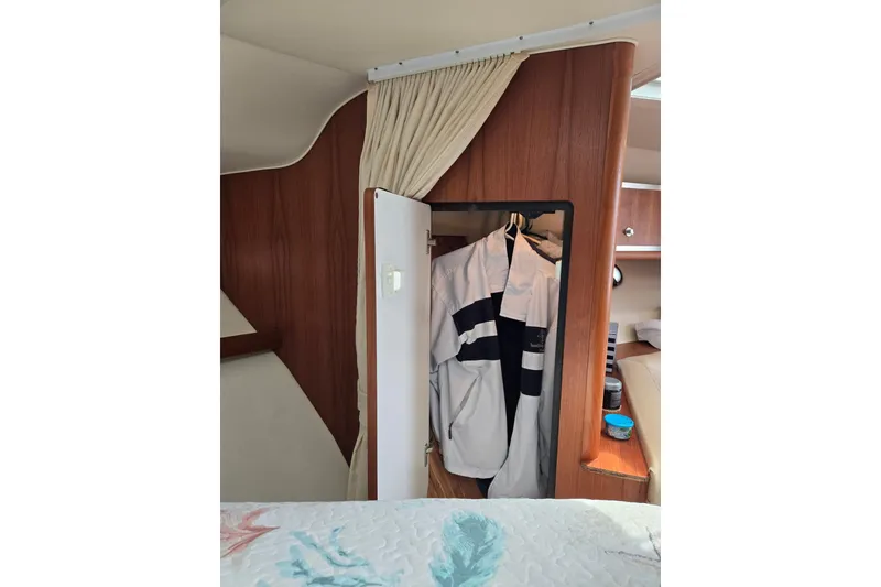 Slide: The Image of Interior of 2006 Tiara Yachts 3200 Open with closet and hanging jacket. - 37