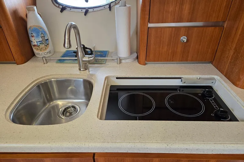 Slide: The Image of 2006 Tiara Yachts 3200 Open kitchen with sink and electric stove. - 39