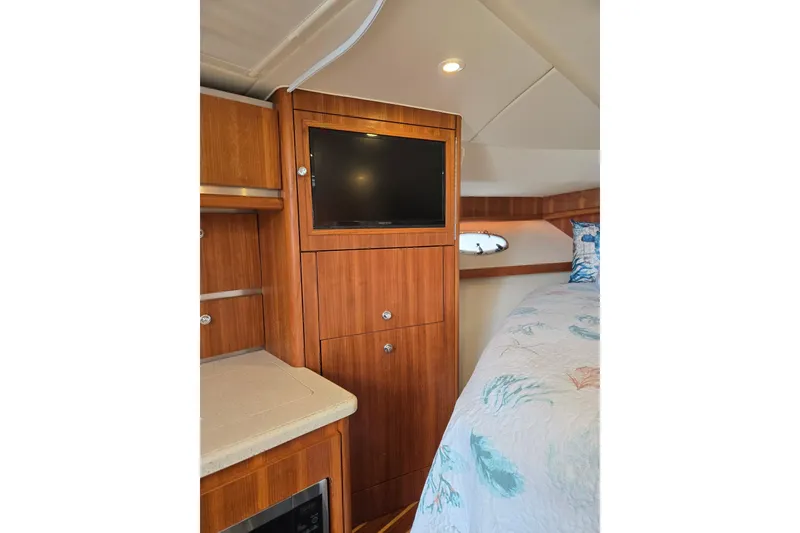 Slide: The Image of 2006 Tiara Yachts 3200 Open cabin interior with wood cabinetry and TV. - 40