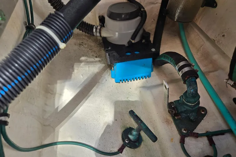 Slide: The Image of Bilge area of a 2006 Tiara Yachts 3200 Open, showing hoses and pump components. - 45