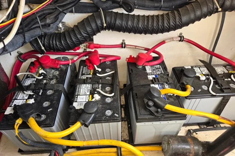 Slide: The Image of Battery compartment of a 2006 Tiara Yachts 3200 Open, featuring multiple marine batteries. - 46