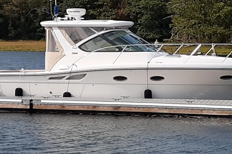Slide: The Image of 2006 Tiara Yachts 3200 Open docked on a calm lake with lush greenery. - 5