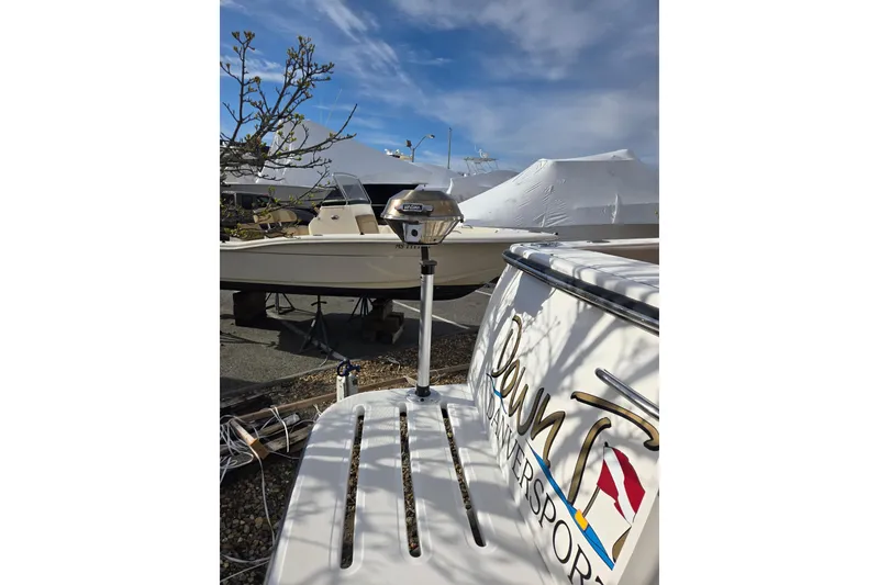 Slide: The Image of 2006 Tiara Yachts 3200 Open in a marina, with clear blue sky. - 9
