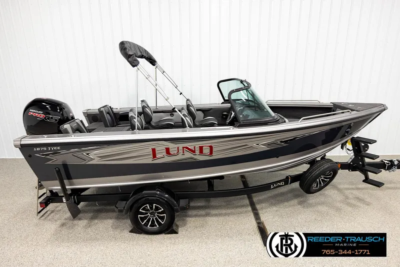The Image of 2026 Lund 1875 Tyee boat with Mercury Pro XS engine on trailer in showroom. - 1