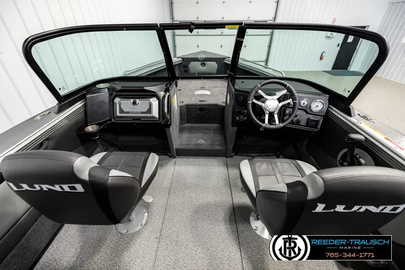 Slide: The Image of Interior view of 2026 Lund 1875 Tyee boat with dual seats and steering console. - 13