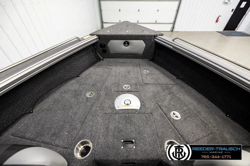 Slide: The Image of 2026 Lund 1875 Tyee boat interior with carpeted deck and storage compartments. - 14