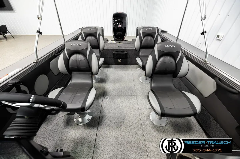 Slide: The Image of 2026 Lund 1875 Tyee boat interior with four cushioned seats and steering wheel. - 16
