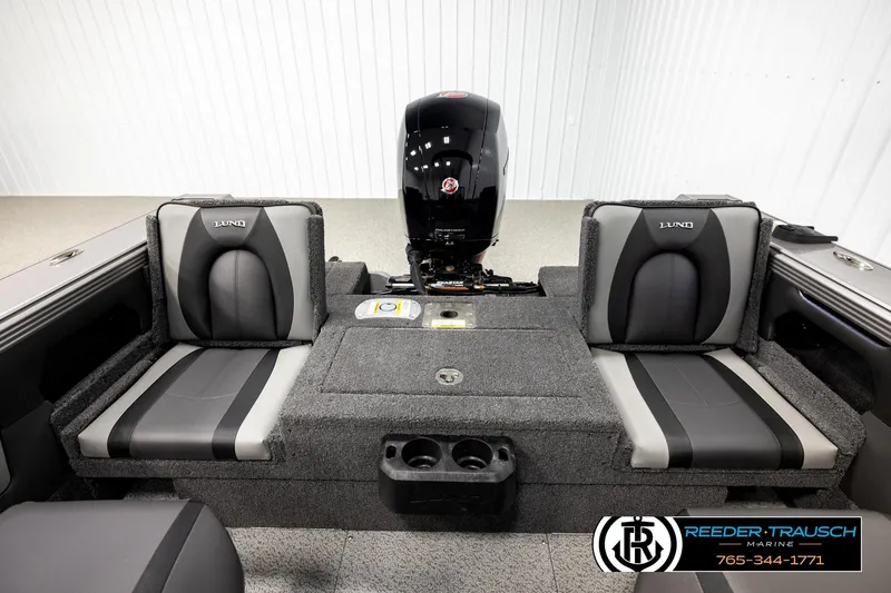 Slide: The Image of 2026 Lund 1875 Tyee boat interior with dual seats and motor, showcased by Reeder-Trausch Marine. - 17