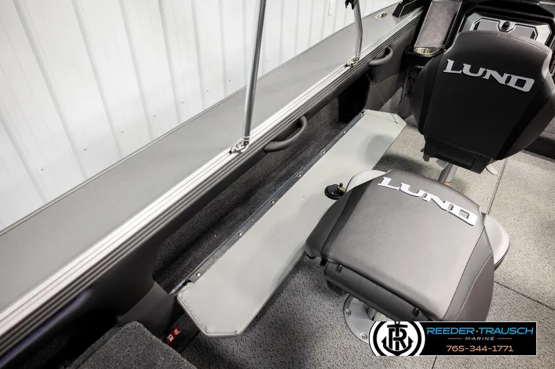 Slide: The Image of 2026 Lund 1875 Tyee boat interior with branded seating and storage compartments. - 21