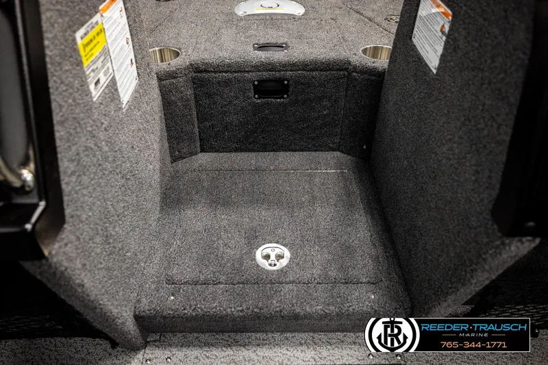 Slide: The Image of 2026 Lund 1875 Tyee boat interior with carpeted flooring and storage compartments. - 24