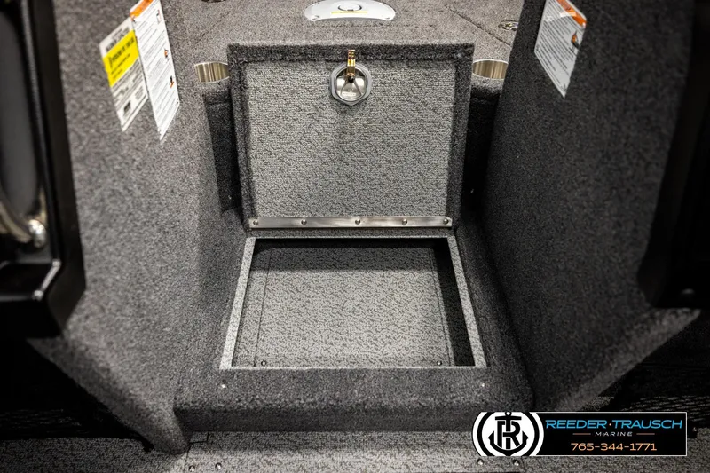Slide: The Image of Interior storage compartment of 2026 Lund 1875 Tyee boat, featuring carpeted finish. - 25