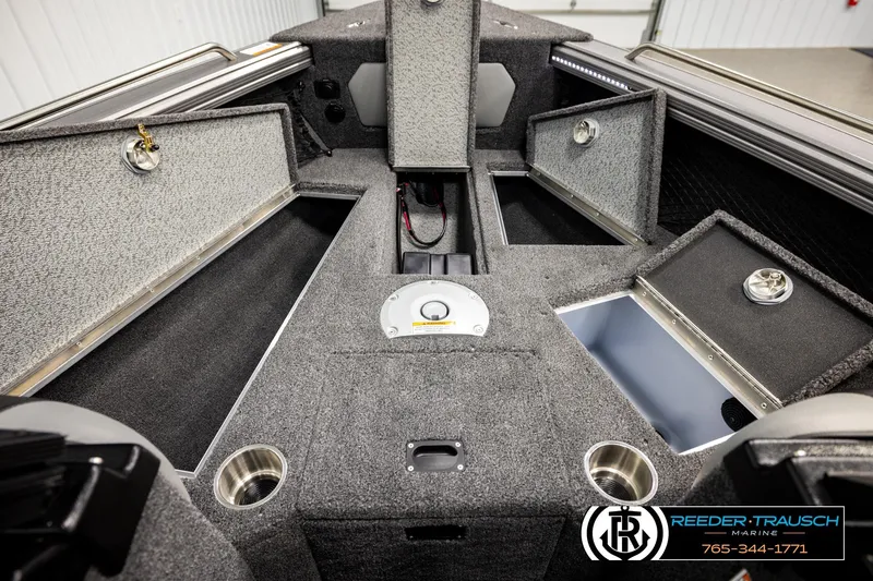 Slide: The Image of 2026 Lund 1875 Tyee boat interior with storage compartments and cup holders. - 28