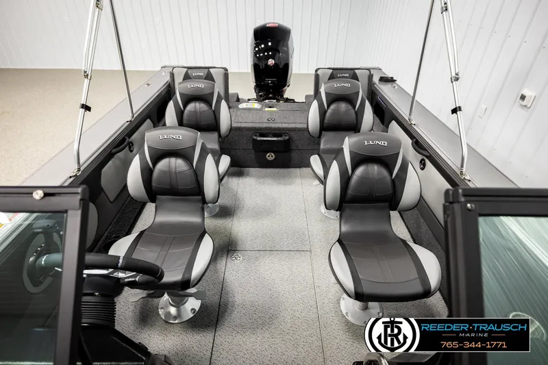 Slide: The Image of 2026 Lund 1875 Tyee boat interior with gray seating and steering wheel. - 30
