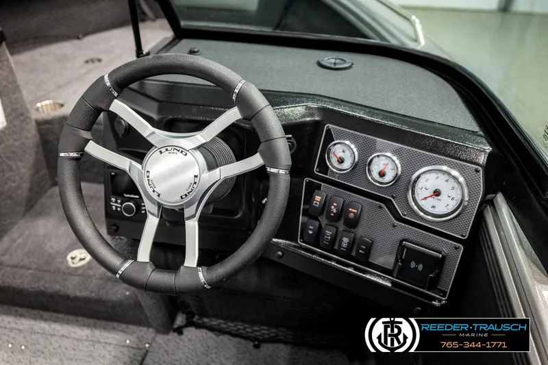 Slide: The Image of 2026 Lund 1875 Tyee boat dashboard with steering wheel and instrument panel. - 31