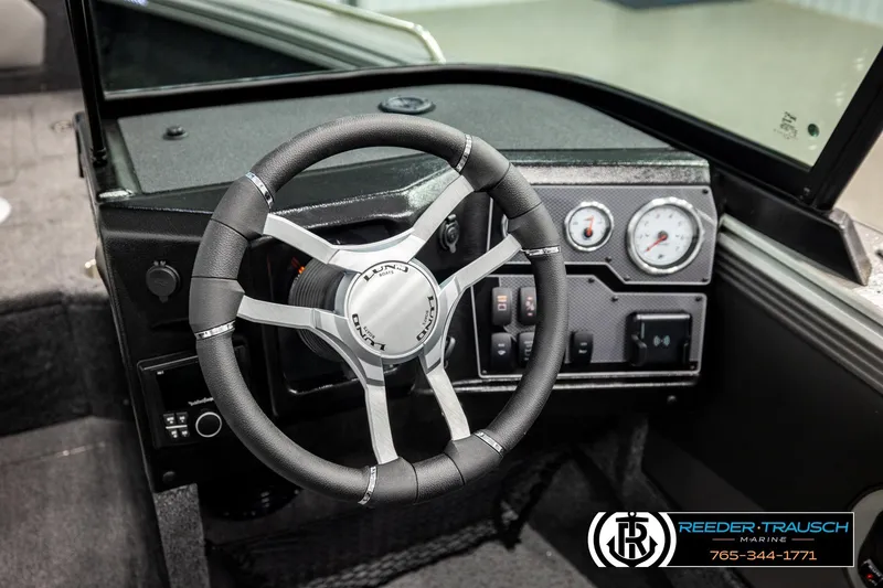 Slide: The Image of 2026 Lund 1875 Tyee boat dashboard with steering wheel and gauges. - 32