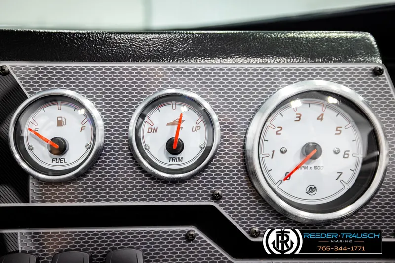 Slide: The Image of Dashboard gauges of 2026 Lund 1875 Tyee boat, showing fuel, trim, and RPM indicators. - 35