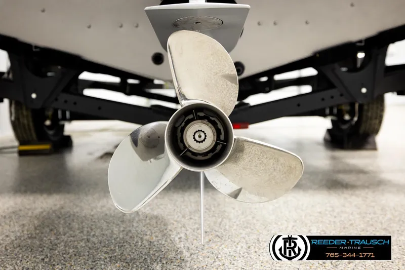 Slide: The Image of 2026 Lund 1875 Tyee boat propeller in a showroom, featuring Reeder-Trausch Marine branding. - 49