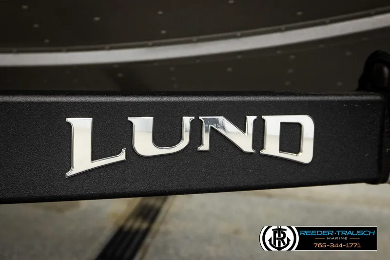 Slide: The Image of 2026 Lund 1875 Tyee boat logo on black surface, Reeder-Trausch Marine branding visible. - 53