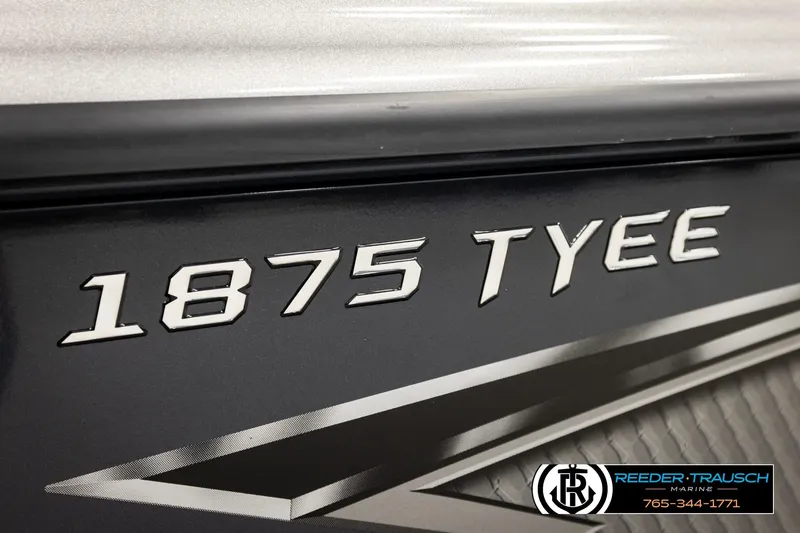 Slide: The Image of 2026 Lund 1875 Tyee boat model nameplate with Reeder-Trausch Marine branding. - 55
