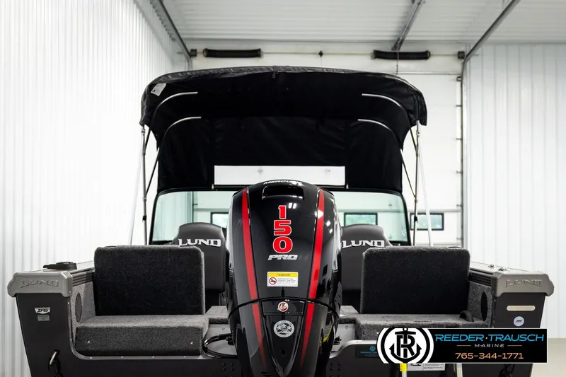 Slide: The Image of 2026 Lund 1875 Tyee boat with 150 HP engine in a showroom. - 6