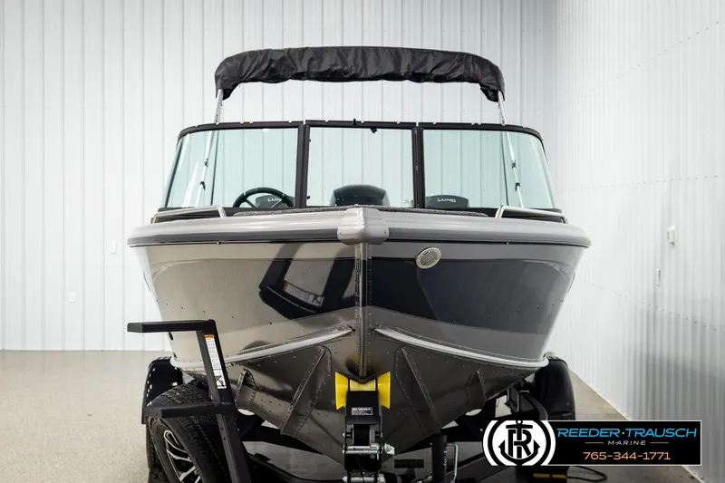 Slide: The Image of 2026 Lund 1875 Tyee boat in showroom, front view with trailer. - 7