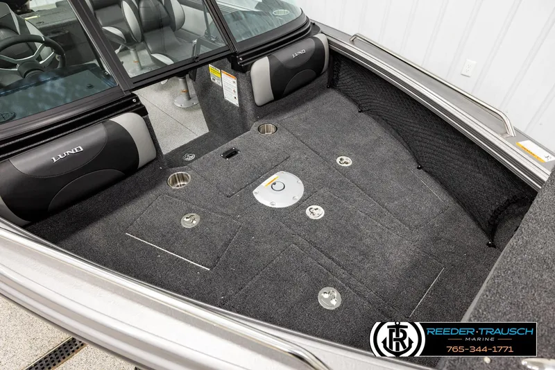Slide: The Image of 2026 Lund 1875 Tyee boat interior with carpeted flooring and seating. - 8