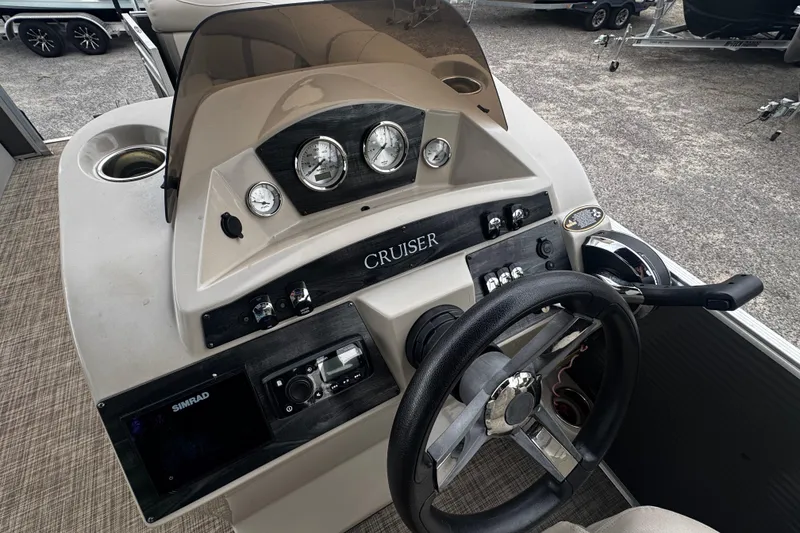 Slide: The Image of Steering console of a 2020 Harris Cruiser 210 boat with gauges and controls. - 3