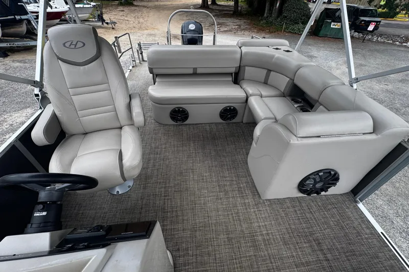 Slide: The Image of 2020 Harris Cruiser 210 boat interior with plush seating and modern steering console. - 4
